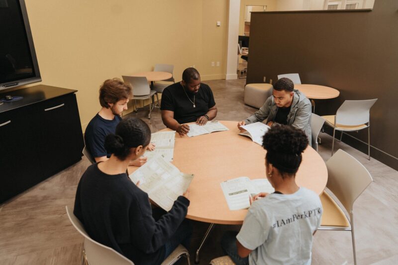 Students studying at a round table in an office