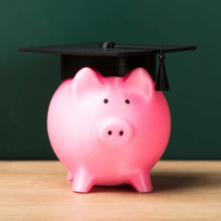 pink piggy bank with graduation cap on