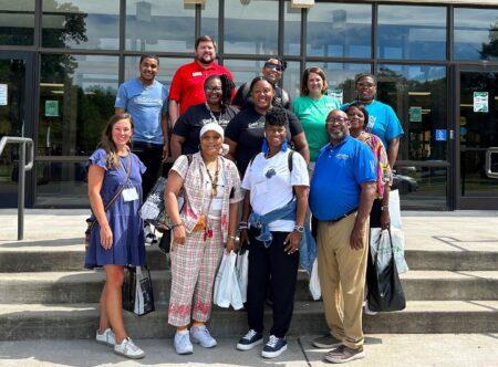 group photo on steps of participants in tour